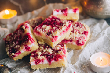 Delicious pie with raspberries and curd cheese. Pieces of pie on the table