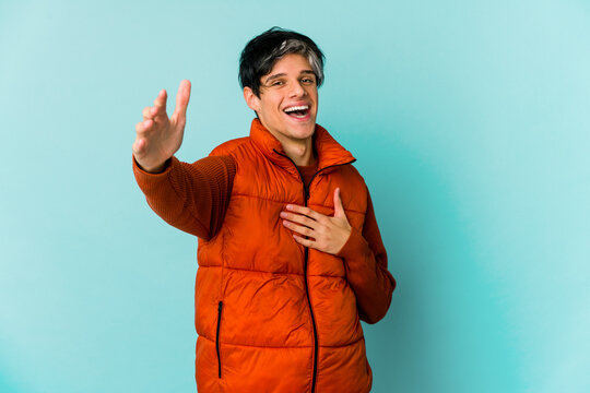 Young caucasian skinny man expressing emotions isolated on blue background