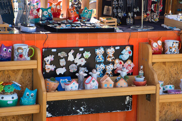Handmade clay pottery and ceramic souvenir cats and owls on the holiday market in Novi Sad, Serbia