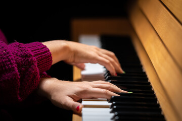 Hands of a girl playing the piano