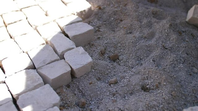 paver working on traditional portuguese cobblestone pavement 4k