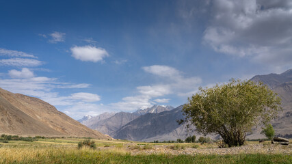 Panoramic view of the start of Wakhan Corridor with snow-capped Hindu Kush mountain range in...