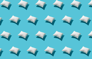 Pattern made of white pillow on serenity pastel blue background. Sleeping concept. Isometric flat lay.