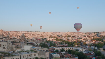 Aerial view from hot air balloon during Sunrise over the fairytale landscape hills of Kapadokya with morning light.