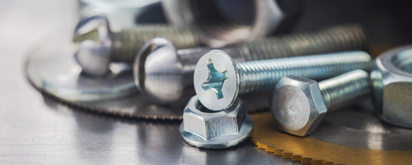 Fototapeta na wymiar nuts, bolts, screws, washers, bearings on a metal steel background.