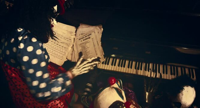 Clowns play the piano. 
