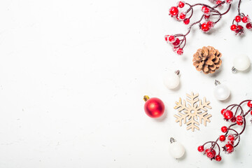Christmas composition with red decorations at white table.
