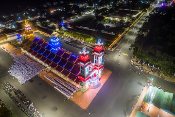 Aerial night view of meditating followers of the Cao Dai religion during Mid Autumn festival of Cao Dai people ( Caodaism) around temple in Tay Ninh city, Vietnam.