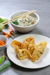 Fried dumplings are served on white plates.