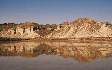 Fototapeta na wymiar Bardenas Reales desert, reflection of the mountain in the water
