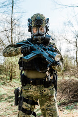 Croatian soldier in Cropat woodland uniform wearing gas mask M95 and assault rifle G36.