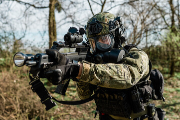 Croatian soldier in Cropat woodland uniform wearing gas mask M95 and assault rifle G36.