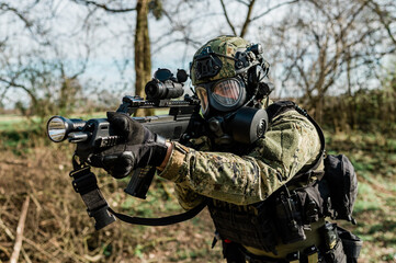 Croatian soldier in Cropat woodland uniform wearing gas mask M95 and assault rifle G36.