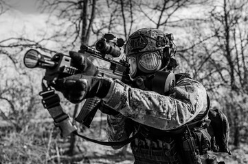 Croatian soldier in Cropat woodland uniform wearing gas mask M95 and assault rifle G36.