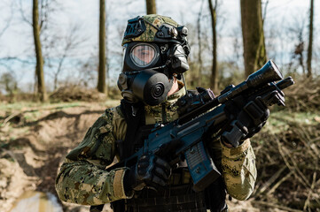 Croatian soldier in Cropat woodland uniform wearing gas mask M95 and assault rifle G36.