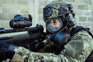 Croatian soldier in Cropat woodland uniform wearing gas mask M95 and assault rifle G36.