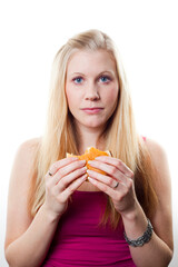 Young blonde woman holding a cheeseburger