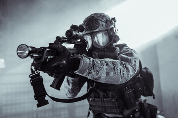 Croatian soldier in Cropat woodland uniform wearing gas mask M95 and assault rifle G36.