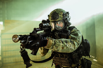 Croatian soldier in Cropat woodland uniform wearing gas mask M95 and assault rifle G36.