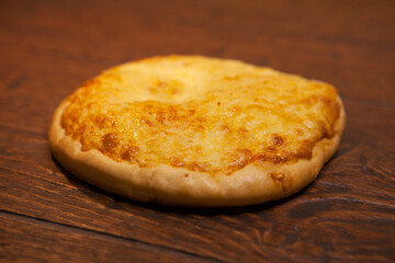 Mini pizza with very much cheese melting