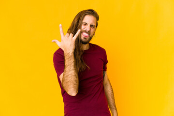 Young man with long hair look showing rock gesture with fingers