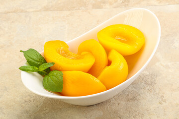 Sweet ripe canned peaches with mint