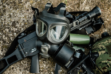Military gas mask M95 surrounded with military gear. Flat lay photo on natural light.