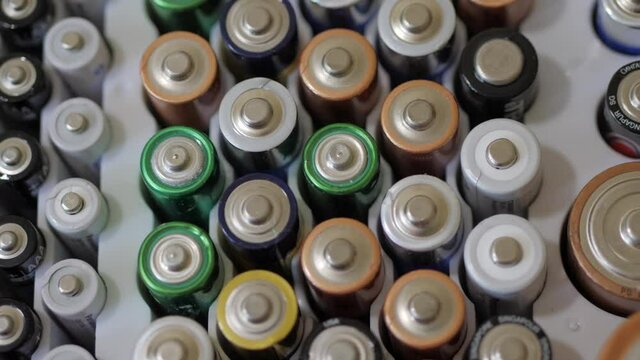 AA and AAA Batteries Lined Up In A White Case CLOSE UP