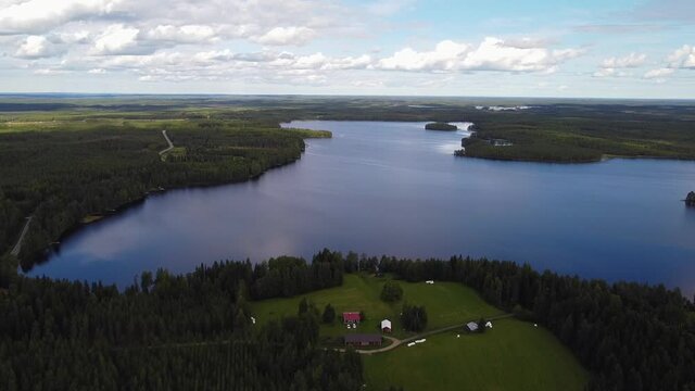Isolated Homestead surrounded by green forest by Tornio river, Finland