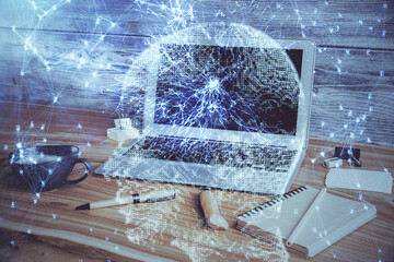 Double exposure of work space with computer and human brain drawing hologram. Brainstorm concept.