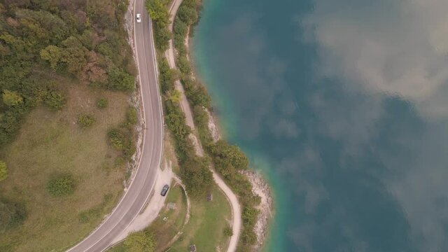 Bird's eye shot of a marvelous reflection of the sky in the lake embraced by charming coastline