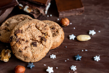 Organic food snack tasty sweet dessert milk dark chocolate chip salt cookie closeup piece fruit orange raspberry hazelnut nuts cinnamon on cocoa cacao powder wooden table for new year Christmas gift