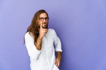 Young man with long hair look contemplating, planning a strategy, thinking about the way of a business.