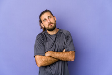 Young man with long hair look funny and friendly sticking out tongue.