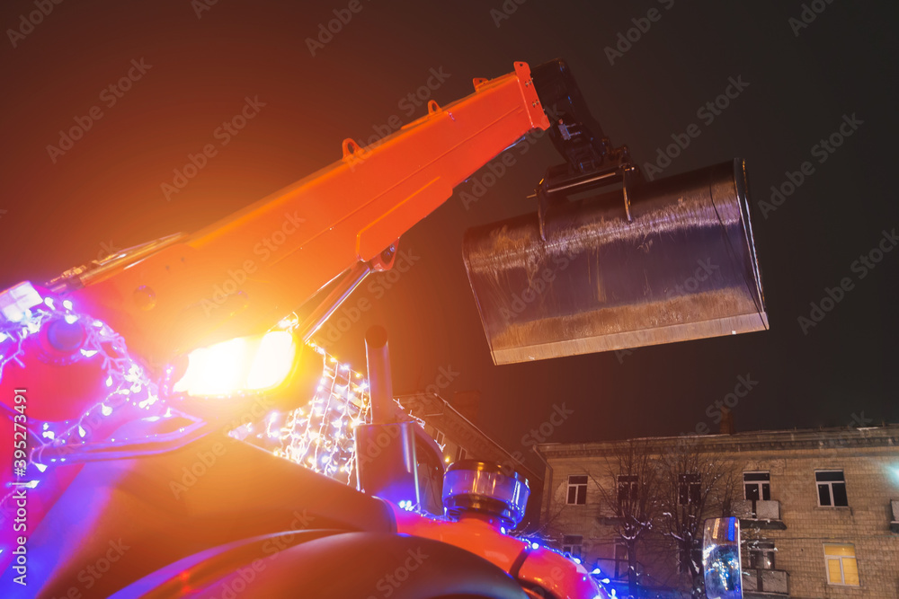 Poster backhoe loader bucket on the background of the evening sky
