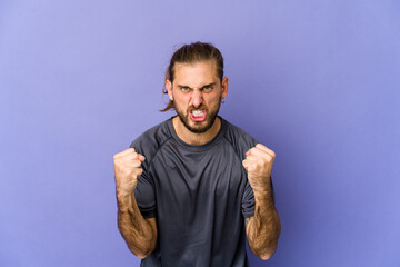 Young man with long hair look tired of a repetitive task.