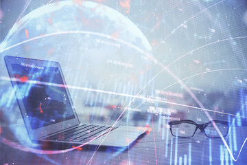 Stock market graph on background with desk and personal computer. Multi exposure. Concept of financial analysis.