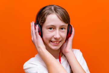 Attractive 12s girl listens to music on headphones closeup