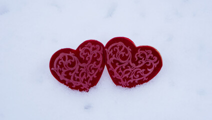 Red hearts on snow