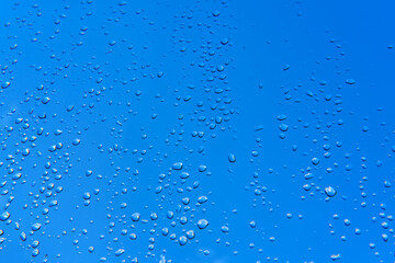 Water drops on the window after the rain, blue sky
