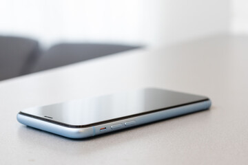 A single mobile phone on gray table