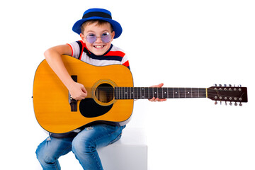 A boy kid plays guitar on a white studio background