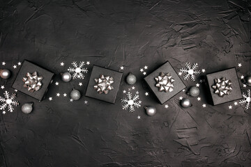 Christmas silver decorations on a black background.