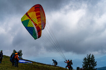 Colorful Paraglider starting to fly