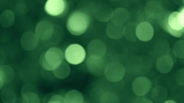 Beautiful abstract glittering shiny green Christmas bokeh 4k video background