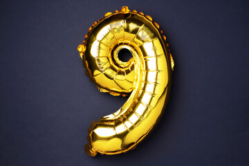 Creative layout. Golden foil balloon number and digit nine 9. Birthday greeting card. Anniversary...