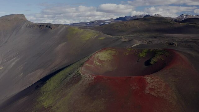 Stunning View Of Raudaskal Crater In Southern Iceland With Red Volcanic Soil - panning drone shot