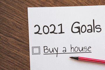 planner of goals and plans for 2021, a sheet of paper with the inscription buy a house from to do...