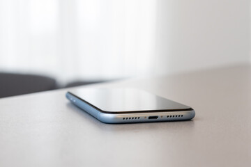 A single mobile phone on gray table