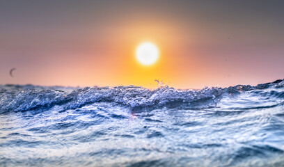 Wave in detail with sunset on Hawaii beach